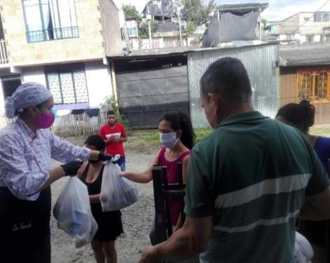 Entrega de un mercado a una familia en la calle